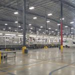 Inside the FedEx shipping warehouse with a truck and shipping equipment.