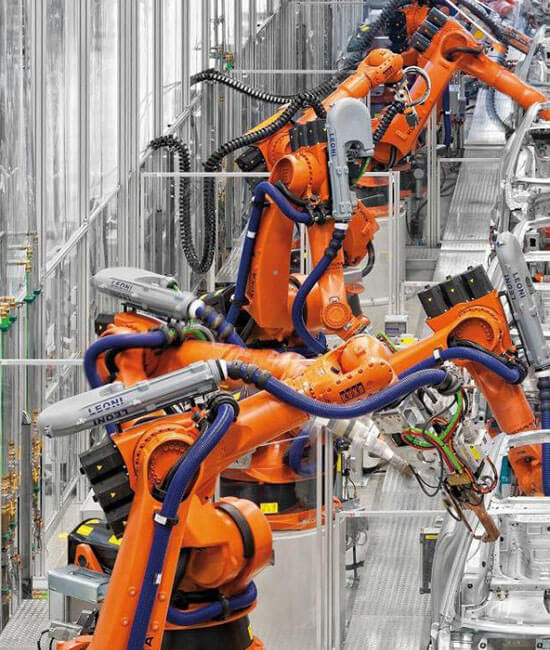 Orange equipment within the manufacturing process.