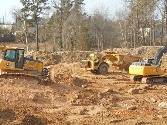 Construction site with three construction trucks