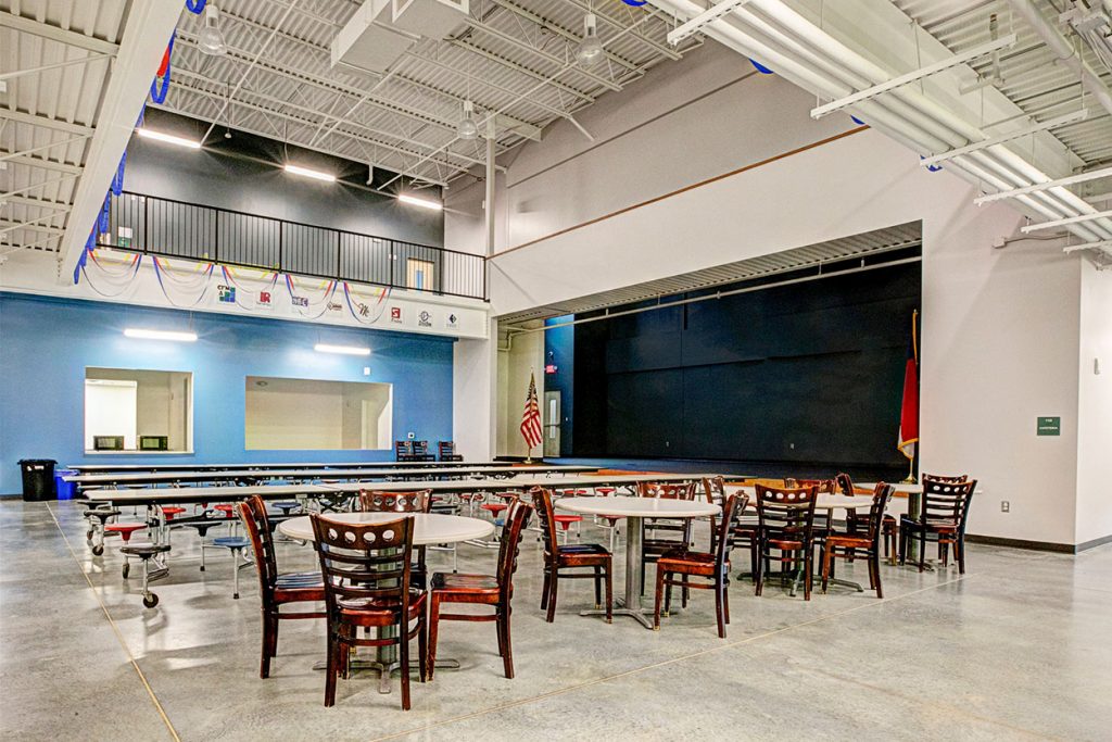 Apprentice Academy High School multipurpose room, cafeteria, work area, and stage charter school