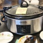 A crockpot filled with chili and a sticky note that says hot for the Annual Chili Bowl competition.