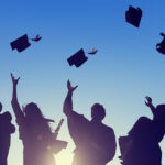 students throwing graduation caps